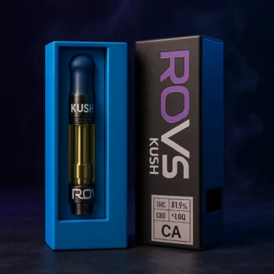 Lifestyle hero shot of Rove Kush Indica vape cartridge with packaging under moody blue and purple glow