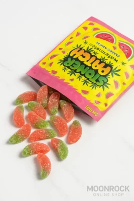 Stoner Patch Watermelon Gummies 500mg spilling from package on white marble surface with Moonrock Online Shop branding