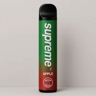 Supreme Apple disposable vape on a clean studio background with Moonrock badge. Caption: Crisp Apple flavor in a matte green body with subtle red base fade; even studio light and soft shadow.
