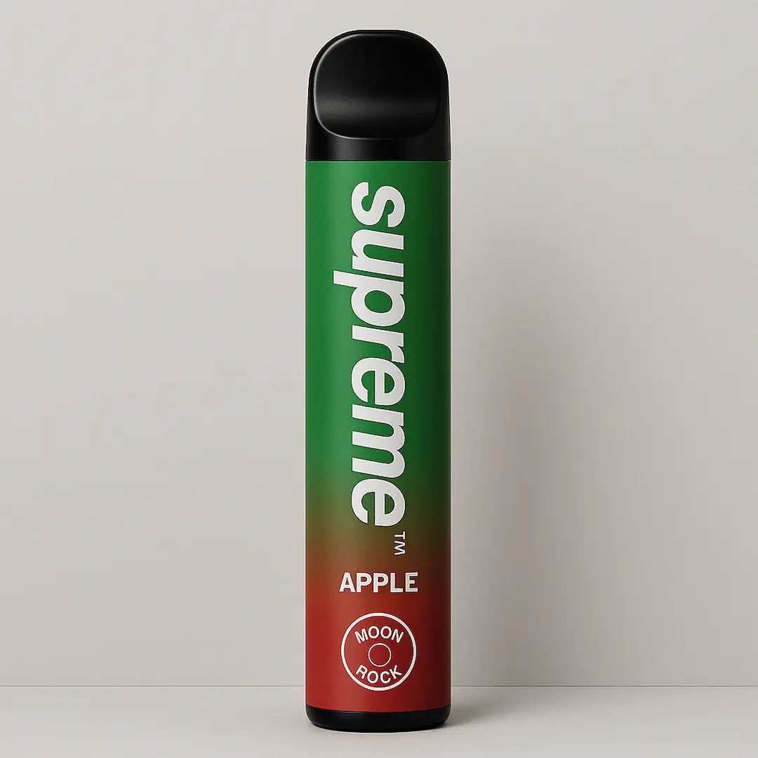 Supreme Apple disposable vape on a clean studio background with Moonrock badge. Caption: Crisp Apple flavor in a matte green body with subtle red base fade; even studio light and soft shadow.