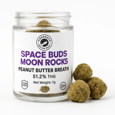 Close-up photo of Space Buds Moon Rocks Peanut Butter Breath strain in a labeled glass jar on a white background, 51.2% THC, COA verified, net weight 7g.