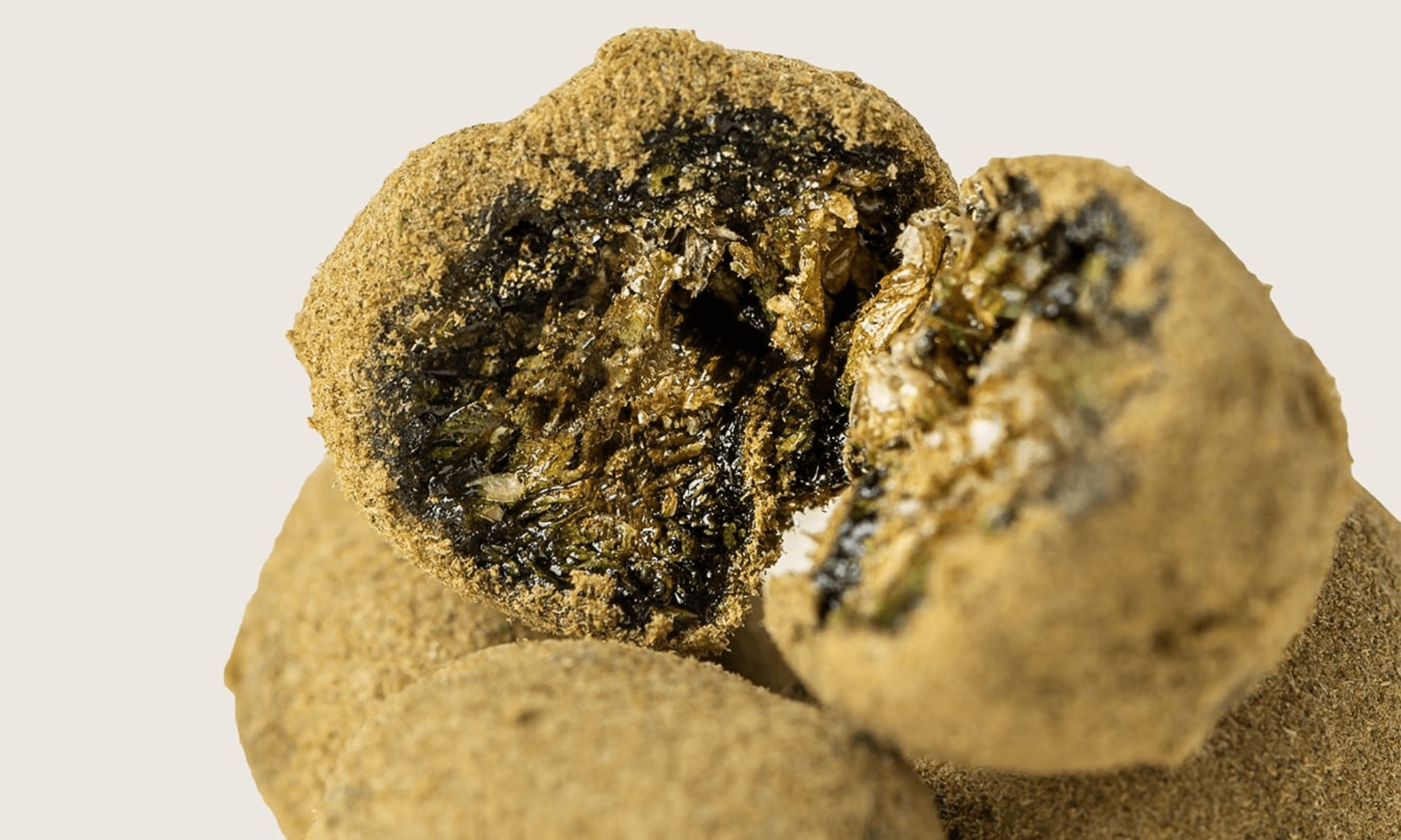 Close-up of a cannabis moonrock showing flower coated with oil and kief