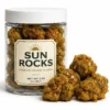 Sun Rocks Premium Infused Flower 3.5G Premium Sun Rocks infused flower in 3.5G clear jar with golden oil-coated kief-covered buds on white background